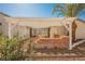 Backyard covered patio with a pergola, tiled floor and seating at 2004 Canterbury Dr, Las Vegas, NV 89119