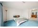 Comfortable bedroom featuring plush blue carpeting and a cozy bed, adjacent to the attached bath at 2004 Canterbury Dr, Las Vegas, NV 89119