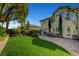 Sprawling backyard features lush lawn, patio, and meticulous landscaping for outdoor enjoyment at 2236 Midvale Ter, Henderson, NV 89074