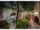 Beautifully landscaped backyard with a stone walkway, decorative fountain, and cozy covered patio at 2236 Midvale Ter, Henderson, NV 89074