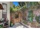 Charming backyard gate leads to a tranquil garden, enhanced by lush greenery and stone accents at 2236 Midvale Ter, Henderson, NV 89074