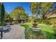 Beautifully landscaped backyard with a fountain, gazebo, patio, and lush greenery at 2236 Midvale Ter, Henderson, NV 89074