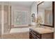 Bathroom featuring glass enclosed shower, soaking tub and granite countertops at 2236 Midvale Ter, Henderson, NV 89074