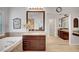 Luxurious bathroom with soaking tub, granite countertops and dark wood cabinets at 2236 Midvale Ter, Henderson, NV 89074