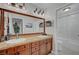 Bathroom featuring double sinks with granite countertops and a glass-enclosed shower at 2236 Midvale Ter, Henderson, NV 89074