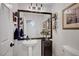 Half bathroom with pedestal sink, framed mirror and decorative accents at 2236 Midvale Ter, Henderson, NV 89074