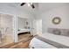 Cozy bedroom featuring wood floors, mirrored closet doors, and natural lighting at 2236 Midvale Ter, Henderson, NV 89074