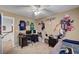 Sports themed bedroom with ceiling fan, large wall decals, and neutral carpeting at 2236 Midvale Ter, Henderson, NV 89074