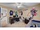 This carpeted bedroom has fun Patriots football wall decor and a ceiling fan at 2236 Midvale Ter, Henderson, NV 89074