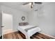 Minimalist bedroom with wood floors, a cozy bed, and neutral decor for a serene retreat at 2236 Midvale Ter, Henderson, NV 89074