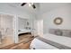 Well-lit bedroom with hardwood floors and mirrored closet doors at 2236 Midvale Ter, Henderson, NV 89074