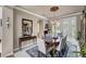 Bright dining room featuring a chandelier, large mirror, seating for six, and elegant decor at 2236 Midvale Ter, Henderson, NV 89074