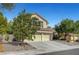 Charming stucco two-story home with a three car garage and sparse landscaping in the front yard at 2236 Midvale Ter, Henderson, NV 89074