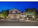 Charming stucco two-story home with a three car garage and manicured landscaping in the front yard at 2236 Midvale Ter, Henderson, NV 89074