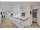Bright hallway featuring neutral walls, carpet flooring, and decorative lighting at 2236 Midvale Ter, Henderson, NV 89074
