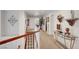 Upstairs hallway with carpet, display tables, and wall art at 2236 Midvale Ter, Henderson, NV 89074