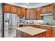 Close-up of a kitchen featuring stainless steel appliances, wood cabinetry, and granite countertops for a modern look at 2236 Midvale Ter, Henderson, NV 89074