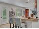 Bright kitchen with an eat-in bar, wood cabinets, granite countertops, and access to the backyard at 2236 Midvale Ter, Henderson, NV 89074