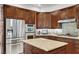 Gourmet kitchen featuring stainless steel appliances, granite countertops, and dark wood cabinetry at 2236 Midvale Ter, Henderson, NV 89074
