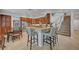 Open kitchen features granite counters, an island with seating, and stainless appliances adjacent to the staircase at 2236 Midvale Ter, Henderson, NV 89074