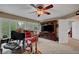 This spacious living room has carpet, a leather couch, plantation shutters and a ceiling fan at 2236 Midvale Ter, Henderson, NV 89074