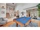 Elegant living room with a billiards table, staircase, high ceilings, and hardwood floors at 2236 Midvale Ter, Henderson, NV 89074