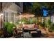 Cozy outdoor patio with comfortable seating, a fire pit, and decorative lighting for evening relaxation at 2236 Midvale Ter, Henderson, NV 89074