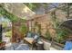 Inviting covered patio with a cozy wicker seating area and charming string lights, perfect for relaxing outdoors at 2236 Midvale Ter, Henderson, NV 89074