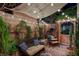 Inviting covered patio featuring a comfortable seating area, decorative plants, and charming string lights at 2236 Midvale Ter, Henderson, NV 89074