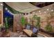 Cozy covered patio with string lights, comfortable seating, and decorative plants creating a relaxing outdoor space at 2236 Midvale Ter, Henderson, NV 89074
