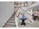 Elegant staircase featuring carpeted steps, white railings, and wood trim at 2236 Midvale Ter, Henderson, NV 89074