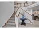Grand staircase with white railings and a decorative table at 2236 Midvale Ter, Henderson, NV 89074