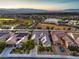 Expansive aerial view showcases a charming neighborhood, a baseball field, and the majestic mountains in the background at 2336 Indigo Island St, Henderson, NV 89044