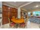 A dining area featuring warm wood tones in the table and cabinets provides an inviting space to share meals at 2336 Indigo Island St, Henderson, NV 89044