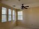 Bedroom with a ceiling fan, window with blinds, and neutral tile flooring at 2461 Brooklyn Bridge St, Las Vegas, NV 89135