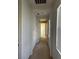 Bright hallway featuring neutral carpet, white walls, and natural light from a window at 2461 Brooklyn Bridge St, Las Vegas, NV 89135