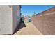 Side yard with low-maintenance gravel and artificial grass, ideal for easy upkeep at 2629 Monte Cevedale St, Henderson, NV 89044
