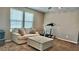 Comfortable bonus room with a cozy couch, coffee table, treadmill, and ample natural light from windows at 2629 Monte Cevedale St, Henderson, NV 89044