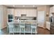 Well-equipped kitchen with stainless steel appliances, granite countertops, and seating at the island at 2629 Monte Cevedale St, Henderson, NV 89044