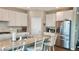 Bright kitchen with stainless steel appliances, spacious granite island, and white cabinetry at 2629 Monte Cevedale St, Henderson, NV 89044