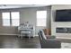 Cozy living area featuring a decorative piano, gray chair, and ample natural light from the large windows at 2629 Monte Cevedale St, Henderson, NV 89044