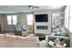 Bright living room with a sleek fireplace, large TV, modern furnishings, and lots of natural light at 2629 Monte Cevedale St, Henderson, NV 89044