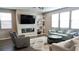 Inviting living room with modern fireplace, built-in shelving, plush seating, and plenty of natural light at 2629 Monte Cevedale St, Henderson, NV 89044