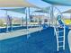 Community playground featuring modern climbing structures and slides, shaded by awnings at 2629 Monte Cevedale St, Henderson, NV 89044