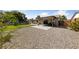 Expansive backyard featuring a patio, rock landscaping, grassy area, and perimeter fencing at 2637 Rialto Rd, Las Vegas, NV 89108