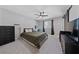 This bedroom has a king-size bed with a vanity and a mounted tv at 2637 Rialto Rd, Las Vegas, NV 89108