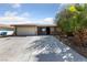 Single story home with desert landscaping, spacious driveway, and attached garage at 2637 Rialto Rd, Las Vegas, NV 89108