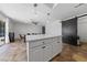 Open kitchen flowing to dining area with center island and modern sliding barn door at 2637 Rialto Rd, Las Vegas, NV 89108