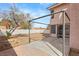 The backyard features a patio area and is surrounded by a white fence, providing privacy and space for outdoor activities at 2802 Secret Canyon Rd, Las Vegas, NV 89074