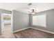 Cozy bedroom with a ceiling fan, neutral paint, and lots of natural light at 2802 Secret Canyon Rd, Las Vegas, NV 89074